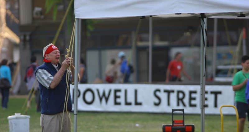 Photo of Doug helping take down a tent at the 2010 Powell Street Festival, taken by Aki Mimoto